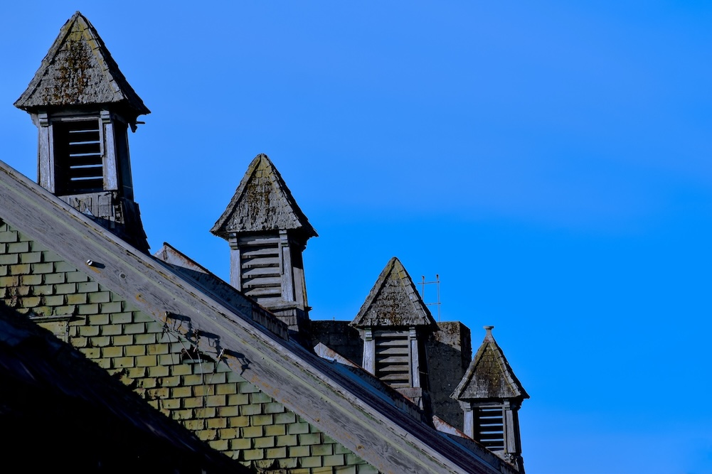 Three towers set against a bright blue sky