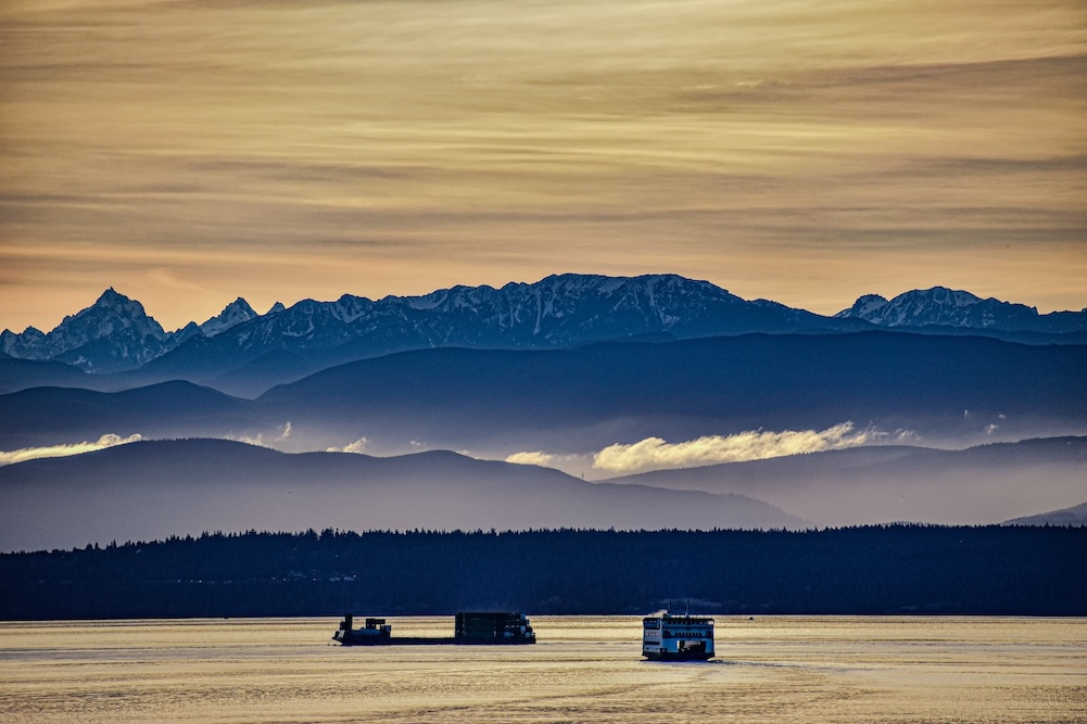 Ferry at sunset against the Olympic Mountains